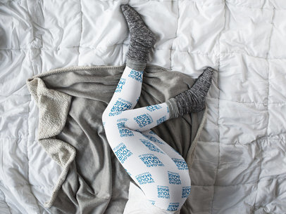 Mockup of Leggings Being Worn by a Girl with Gray Socks Lying on a Bed a15701