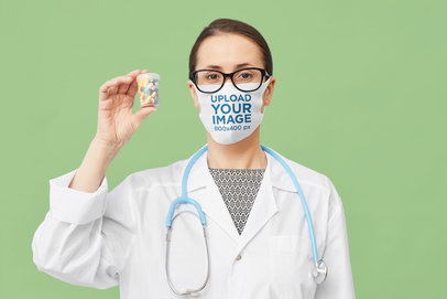 Face Mask Mockup of a Doctor Holding a Pillbox M3720-r-el2