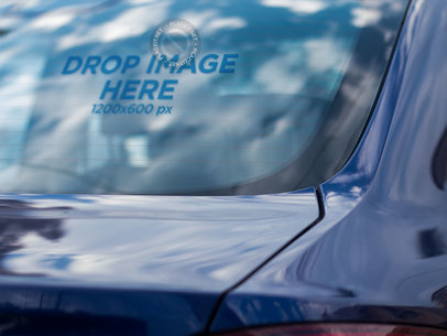 Mockup of a Decal on the Back Window of a Blue Car
