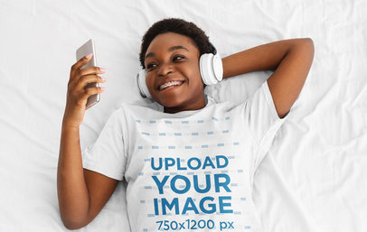 T-Shirt Mockup of a Woman with Braces and a Set of Headphones Lying on Her Bed 