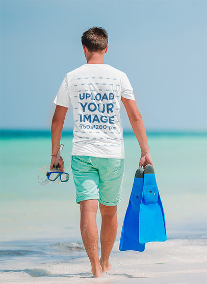 Back-View T-Shirt Mockup Featuring a Man Walking on the Beach