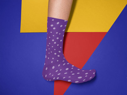 Mockup of a Mans Foot Wearing a Sock Against a Tricolor Surface a15612