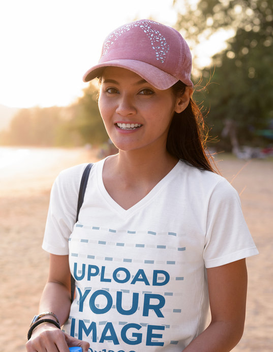 V-Neck T-Shirt Mockup of a Woman Smiling at the Beach