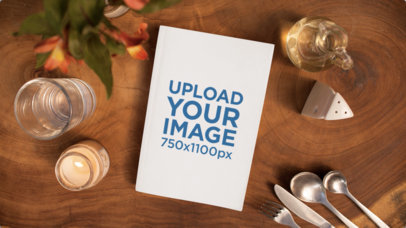 Book Lying on a Romantic Dinner Table with Things Moving Near it