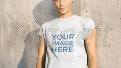 Man Wearing a Round Neck Tee Video Against a Concrete Wall