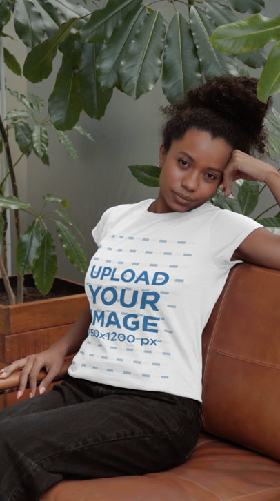 Video of a Woman Sitting on a Couch with a Rounded-Neck Tee