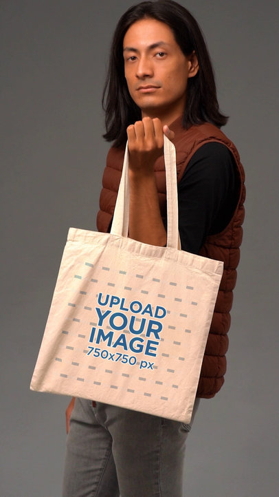 Video of a Long-Haired Man Holding a Tote Bag