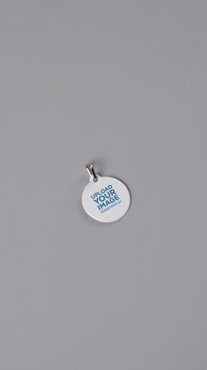 Video of a Dog Tag Placed Over a Grey Background 5979v