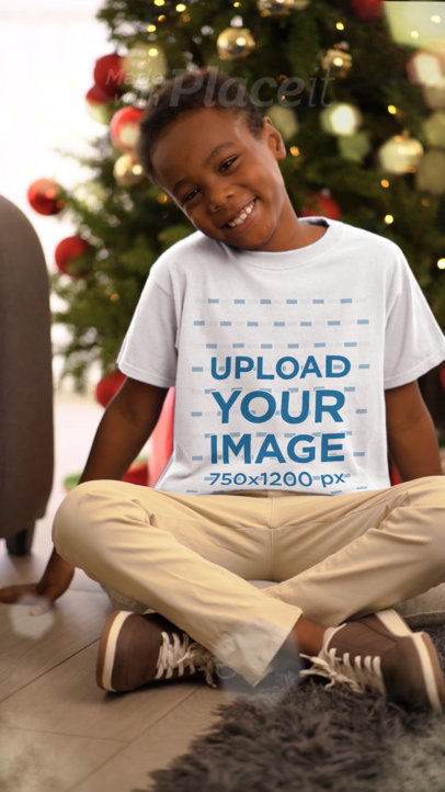 T-Shirt Video Featuring a Cute Boy Posing in a Christmas-Themed Setting