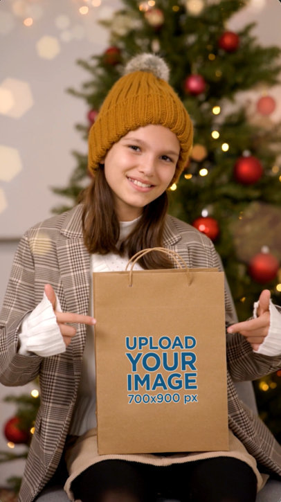 Video of a Happy Girl Pointing at a Christmas Gift Bag