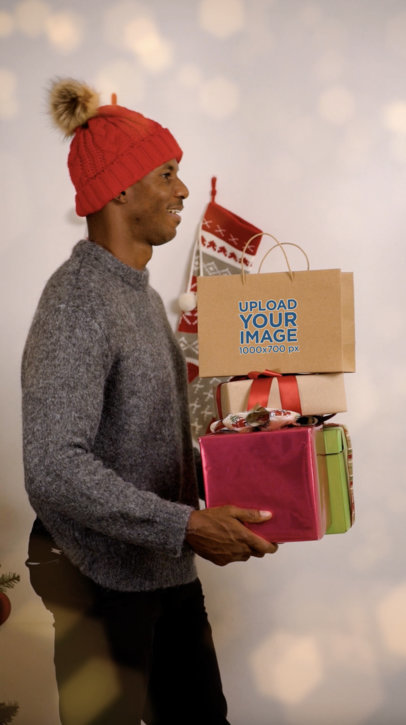 Video of a Man Carrying a Gift Bag and a Pile of Christmas Presents