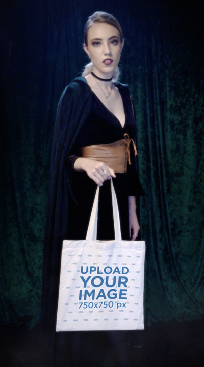 Video of a Woman in a Wicca Outfit Holding a Sublimated Tote Bag