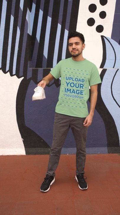 T-Shirt and Hoodie Video Mockup Featuring a Man Making a TikTok Fashion Challenge