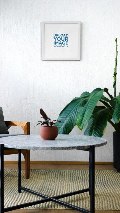 Video of a Person Hanging a Squared Art Print on a Wall