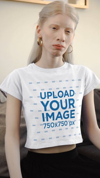 Crop Top Video Featuring a Serious Woman Sitting on a Couch