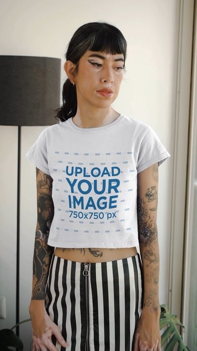 Crop Top Video of a Tattooed Woman Standing by a Window