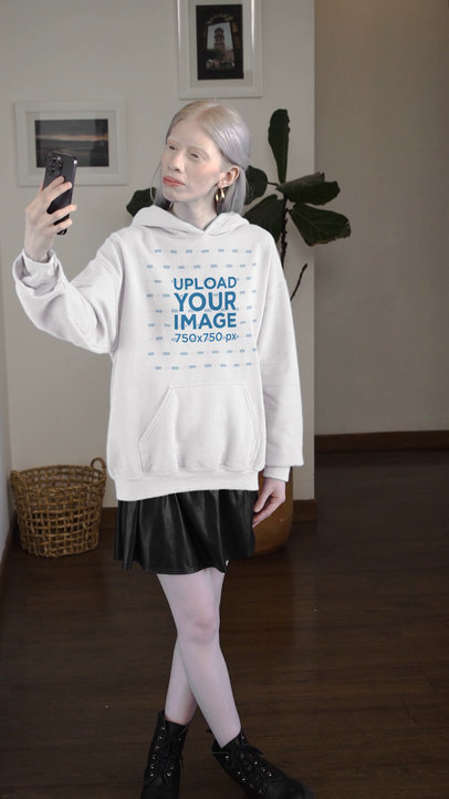 Video of a Woman Taking a Selfie While Wearing a Pullover Hoodie