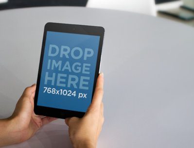 Tablet Mockup of a Young Woman Using an iPad Mini at the Office