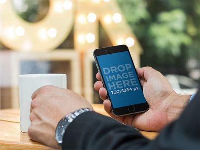 Stock Photo of a Businessman Using an iPhone 6 in Coffee Shop