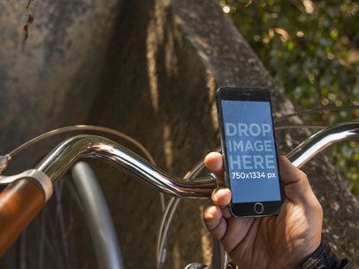 iPhone 6 Mockup Featuring a Man Riding a Vintage Bicycle