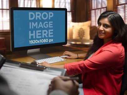 Mockup of a Young Businesswoman at the Office Using an iMac a5148