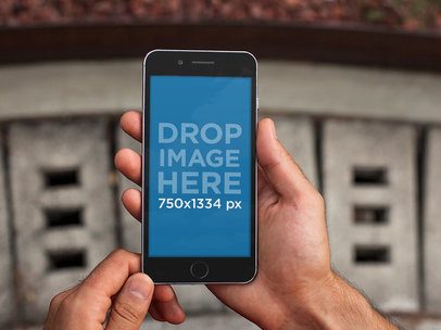 iPhone Mockup Featuring a Man Holding an iPhone 6 