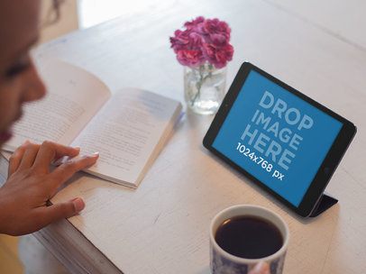 Tablet Mockup of a Lady Reading at a Cafe While Using Her iPad