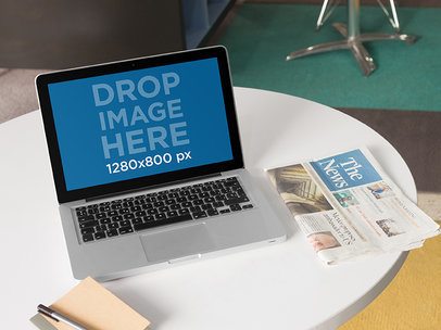 Laptop Mockup Featuring a Macbook Pro at a Design Office