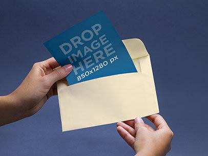 Envelope Mockup Featuring a Person Opening an Envelope