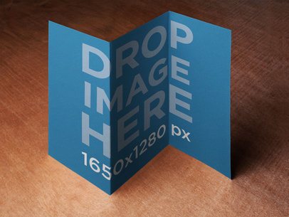 Mockup Featuring a Brochure Standing On Top of a Wooden Surface