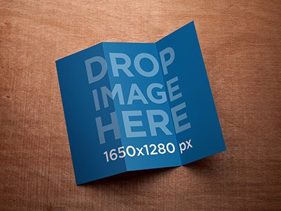 Mockup of a 3 Panel Brochure Lying on Top of a Wooden Surface