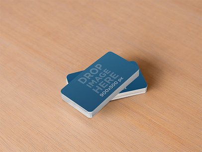 Mockup of a Stack of Business Cards Sitting on Top of a Wooden Desk
