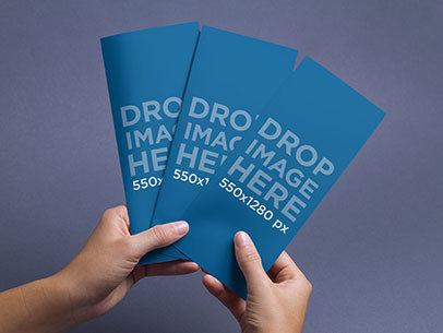 Brochure Mockup of a Person Holding 3 Brochures Against a Colored Backdrop