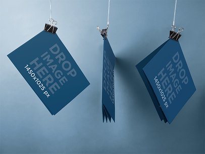 Brochure Mockup of Three Brochures Hung With Paper Clips