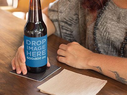 Label Mockup of a Tattooed Woman Having a Beer at a Bar