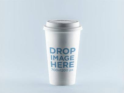 Label Mockup Featuring a Coffee Cup Standing Over a Solid Backdrop