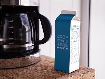 Label Mockup of a Milk Carton Standing Next to a Coffee Machine