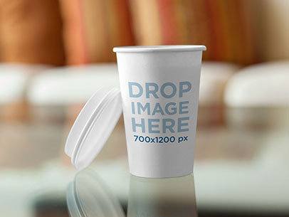 Takeaway Coffee Cup on Top of a Glass Coffee Table Label Mockup