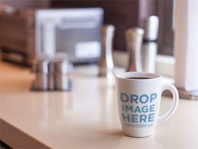 Cup Mockup Featuring a Coffee Cup on Top of a Kitchen Counter