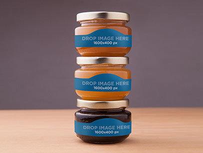 Label Mockup Featuring Three Jars of Honey On Top of a Wooden Surface 