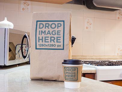 Takeaway Coffee Cup and Paper Bag Mockup on Top of a Kitchen Counter