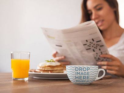 Cup Mockup of a Woman Reading the Newspaper While Having Breakfast 