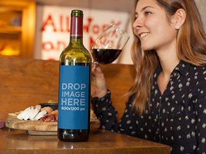 Mockup of a Wine Bottle on Top of a Restaurant Table