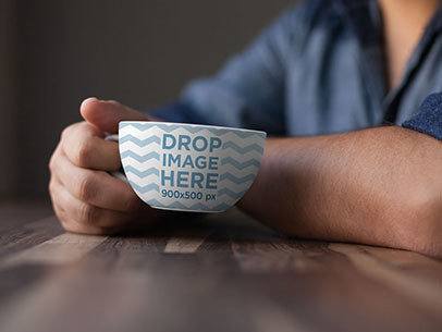 Coffee Cup Mockup of a Man at a Café Having a Coffee