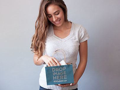 Packaging Mockup of a Young Woman Holding a Shopping Bag