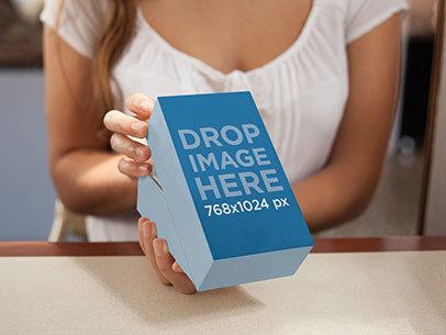 Packaging Mockup Featuring a Woman Opening a Present
