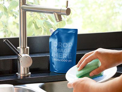 Packaging Mockup of a Liquid Soap Bag Next to a Kitchen Sink