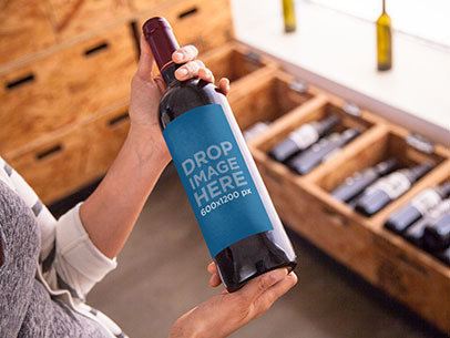 Mockup Featuring a Woman Holding a Wine Bottle 