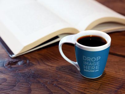 Cup Mockup of a Cup Standing Next to a Book on Top of a Desk