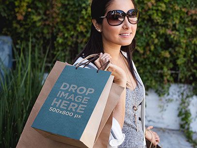 Paper Bag Mockup of a Woman Carrying a Set of Shopping Bags